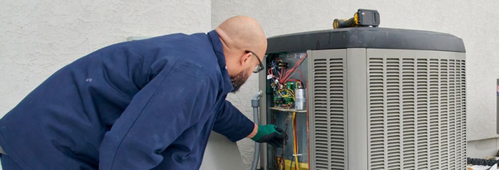 Technician repairing ac unit for a residential customer