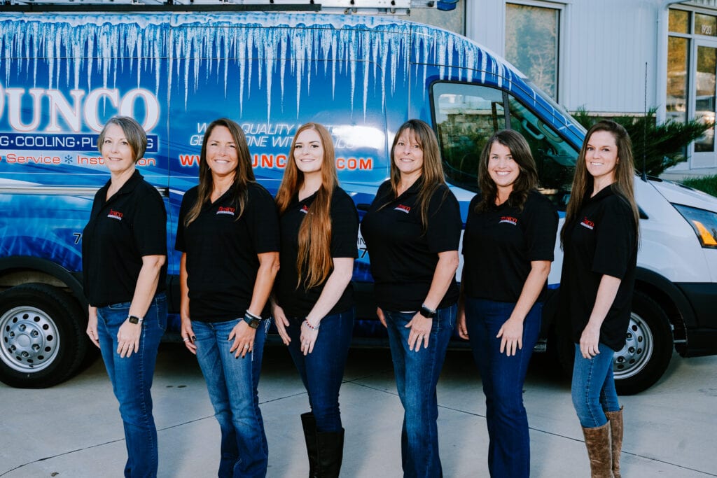 Photo of the Dunco Heating and Cooling office staff in front of a work vehicle