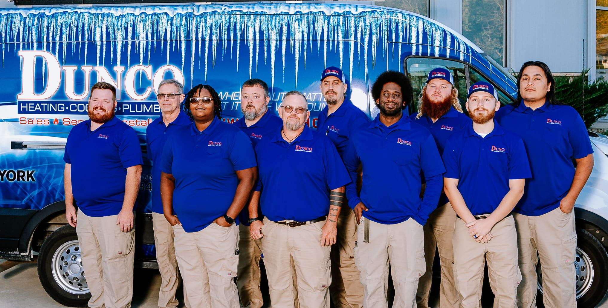 Photo of the Dunco Heating and Cooling Service team in front of a work vehicle