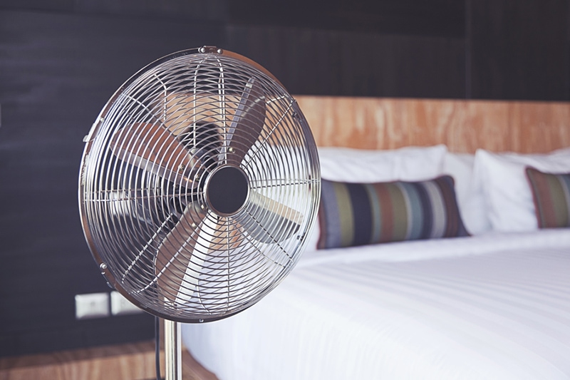 Improve Your Home’s Indoor Air Quality Old electric fan near the bed in the room