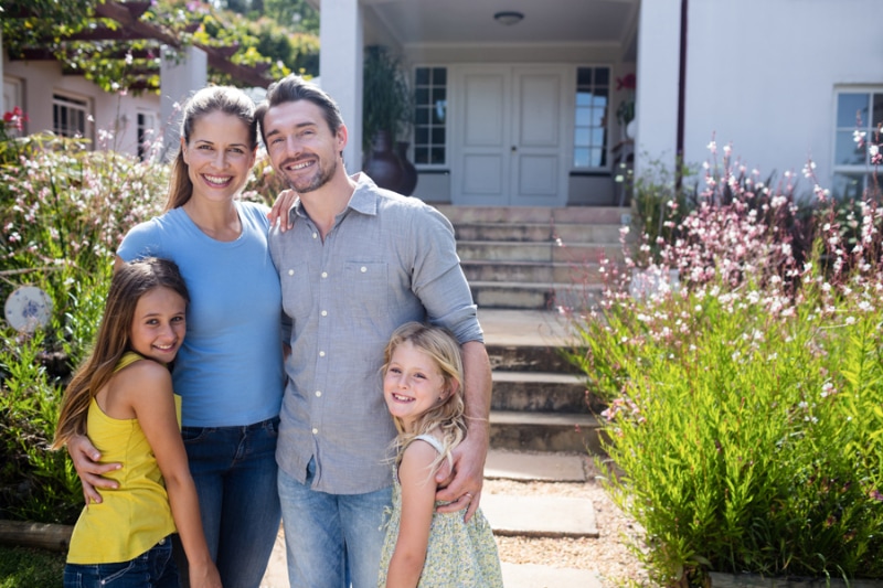 Family standing together on garden path