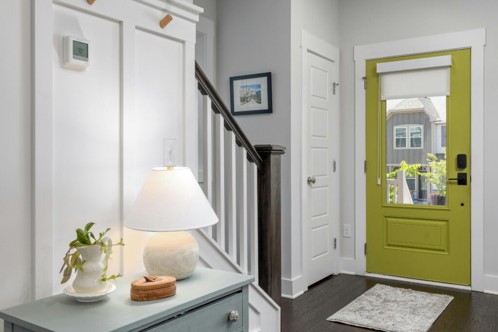 hallway with entry door and thermostat